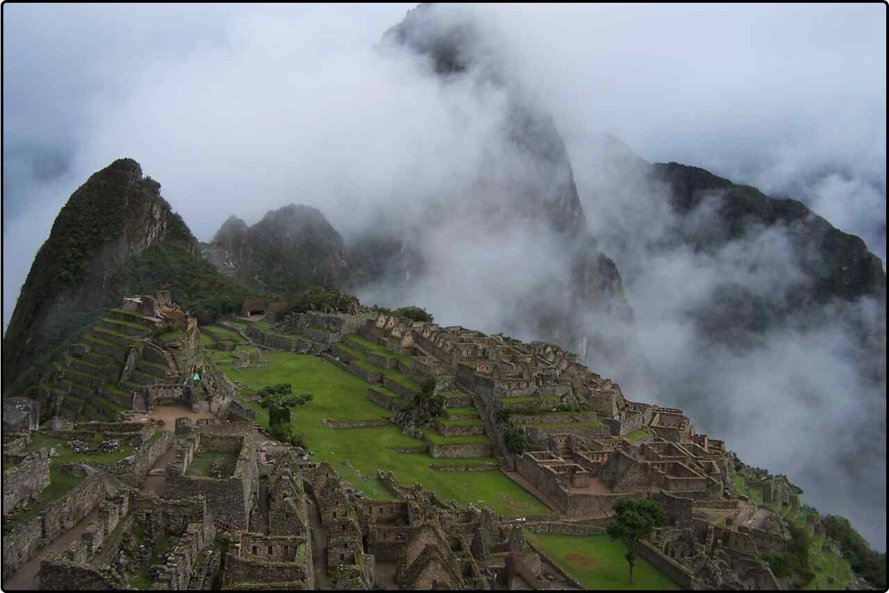 Aerial view of Machu Picchu, showcasing the ancient Incan ruins nestled in the Andes mountains.